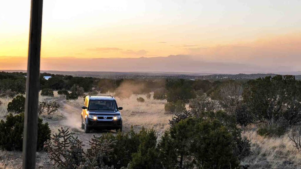 Honda Element exploring the desert at sunset